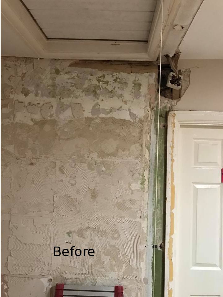 Wall before skimming by our Maidstone plasterers, with old adhesive marks and patched plaster